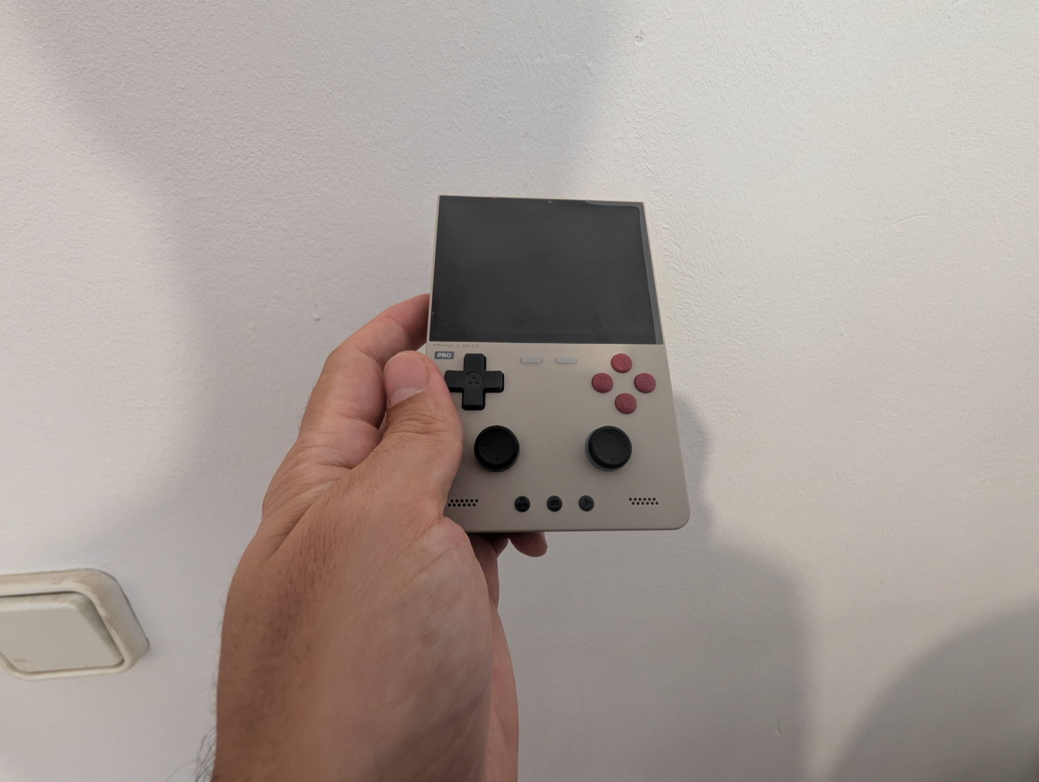 TrimUI Brick Pro rear view showing the shell, grips and shoulder buttons