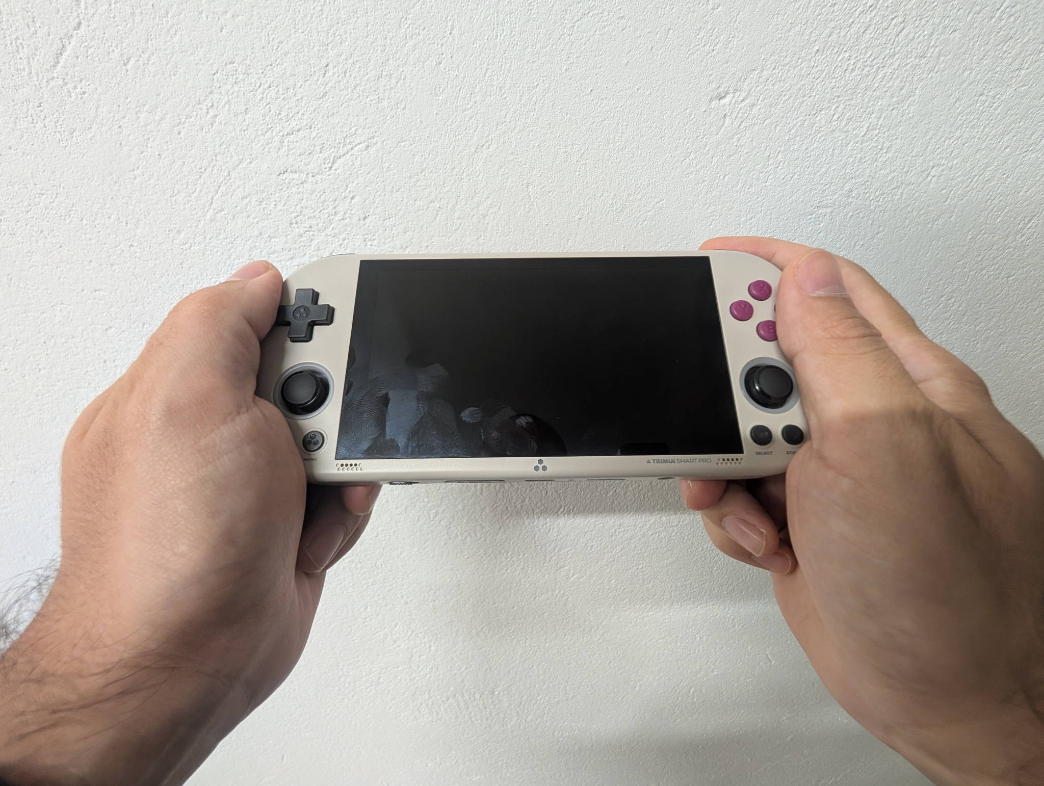 The TrimUI Smart Pro handheld, shown ahead of a head-to-head comparison with the TrimUI Brick Pro