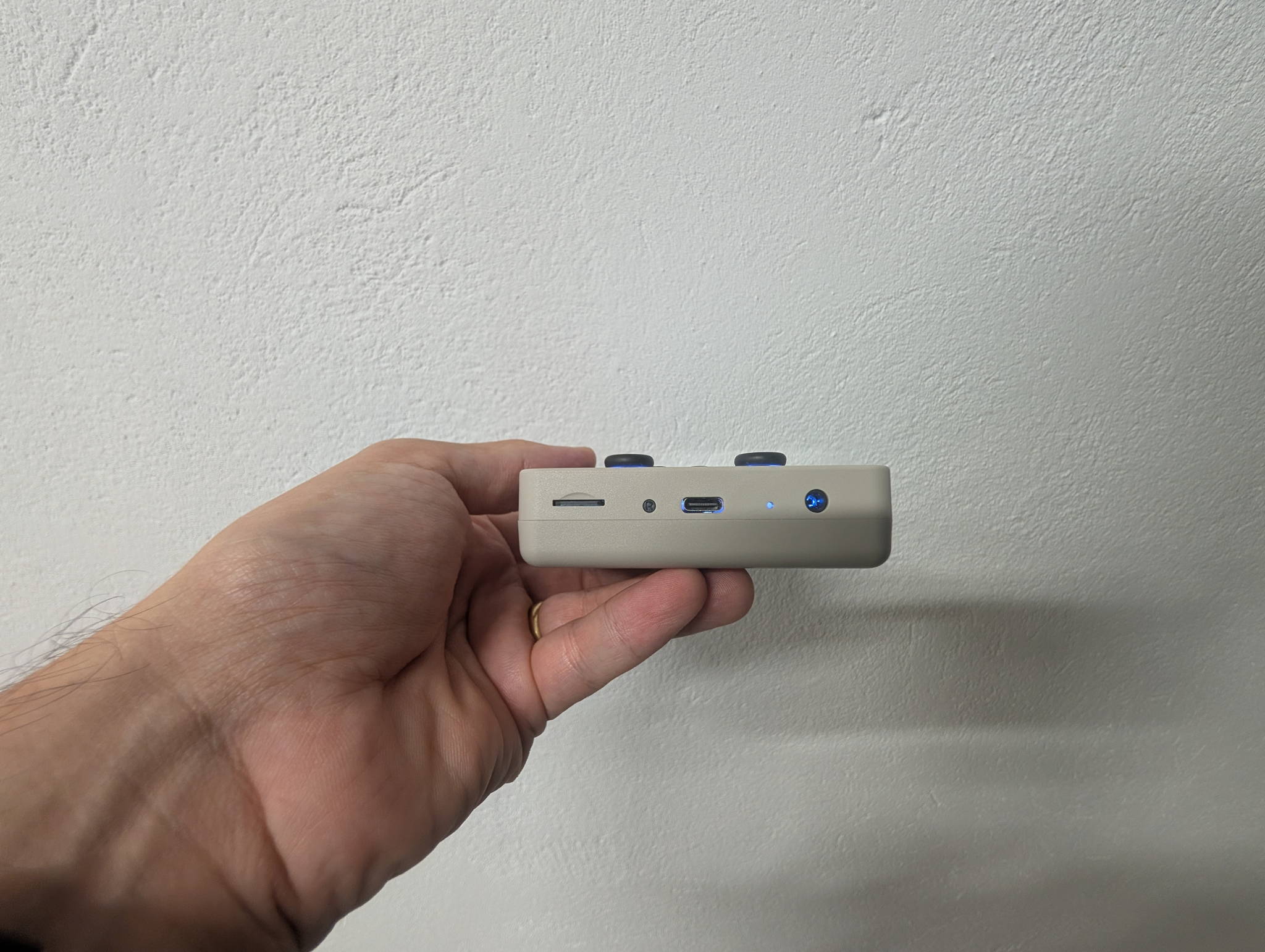 TrimUI Brick Pro angled view showing the dual Hall-effect analog sticks and face buttons