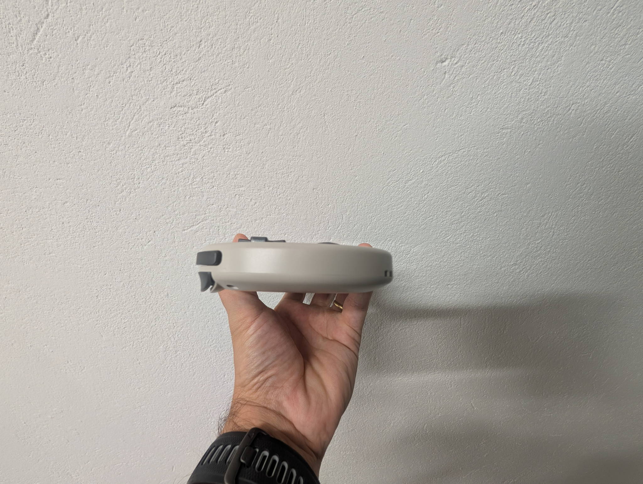 TrimUI Smart Pro from an angle, highlighting the shoulder buttons and RGB-lit analog sticks